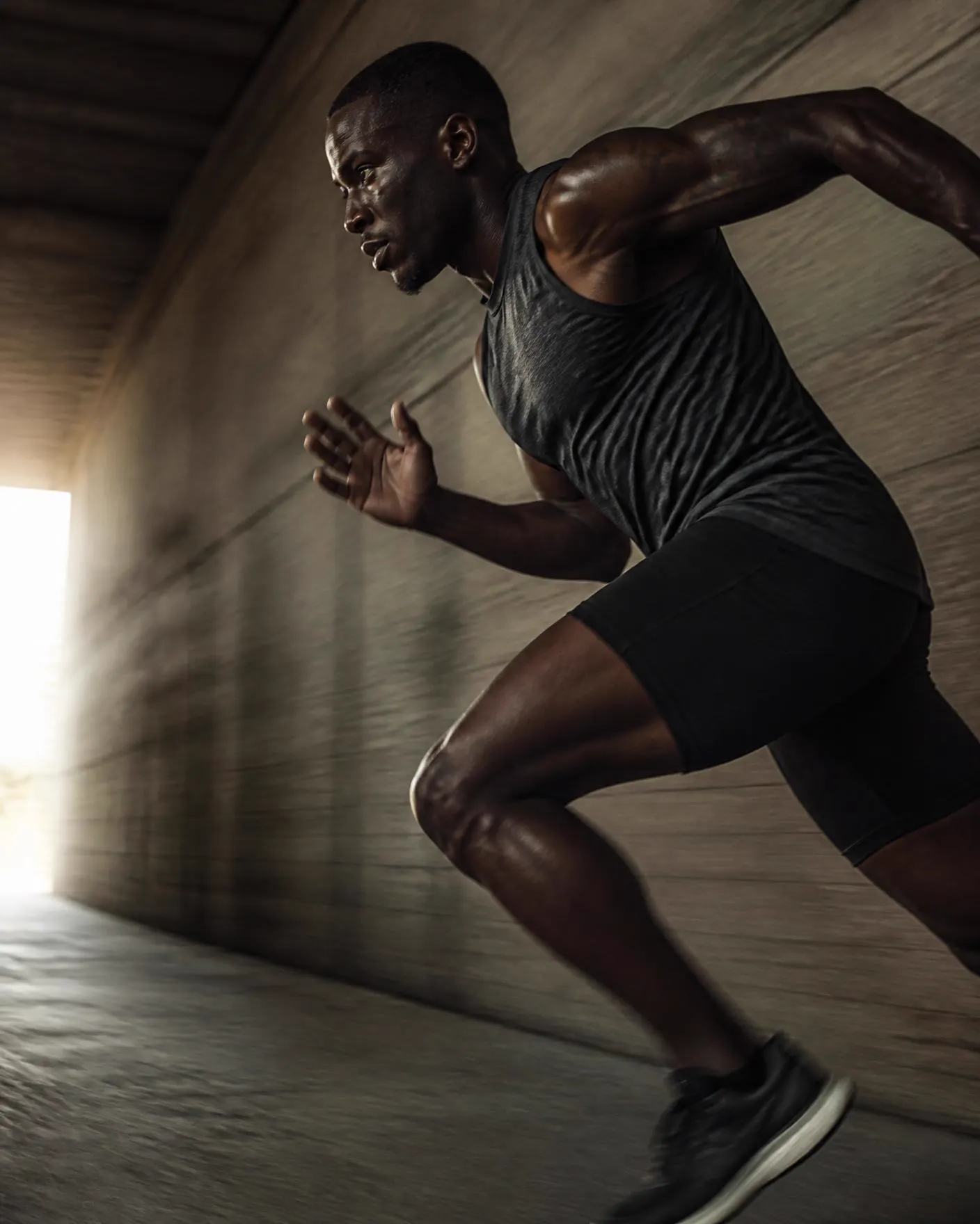 Athlete walking through a corridor toward the light